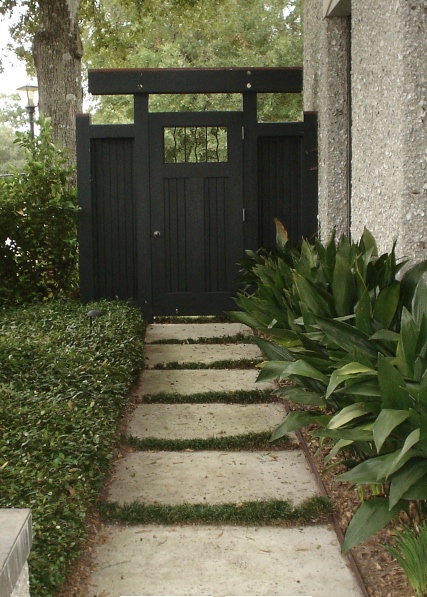 Garden door instead of gate.  formal.  inviting.  pavers with soft joints.